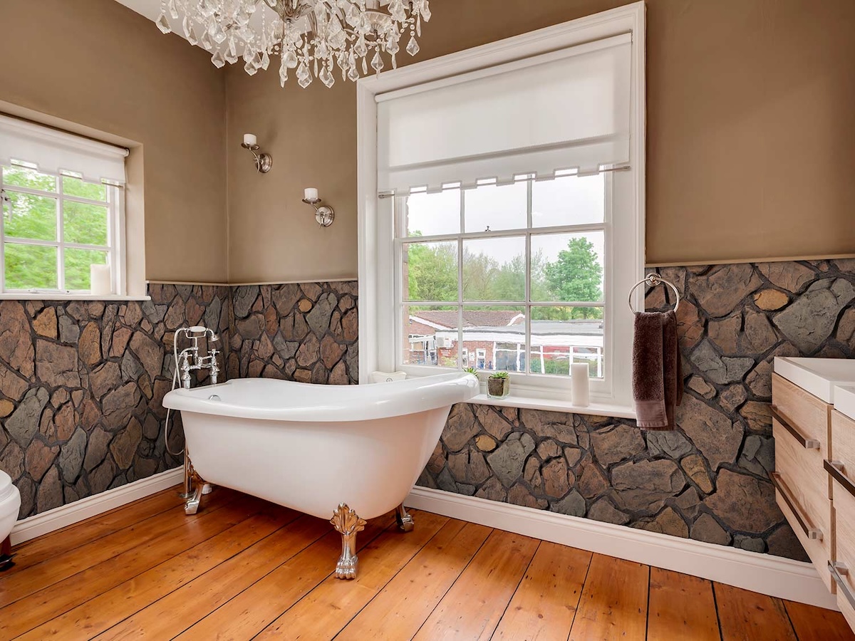 Anson Fieldstone Faux Stone Wall Panel wainscoting in Earth in a luxurious bathroom