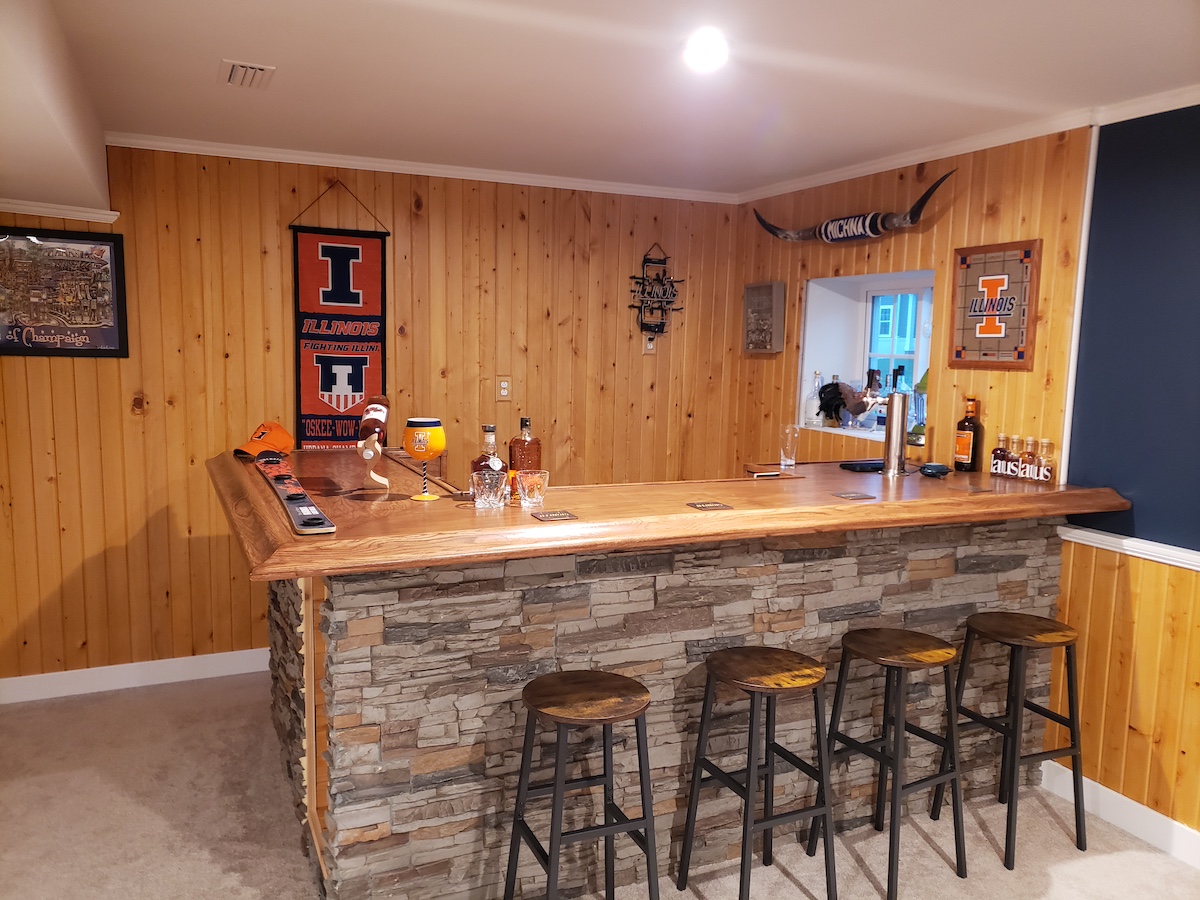 Basement bar crafted with Colorado Dry Stack Faux Stone Wall Panels in Motley Gray for football season